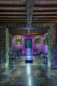 a dining room with tables and purple walls at Casanova di Pescille in San Gimignano
