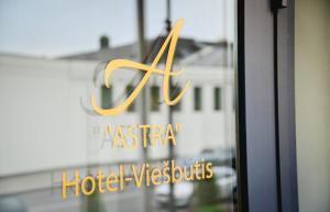 a reflection of a hotel sign in a window at Astra Hotel in Klaipėda