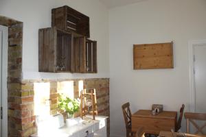 a room with a table and some wooden cabinets at Wramsta B&B in Tollarp