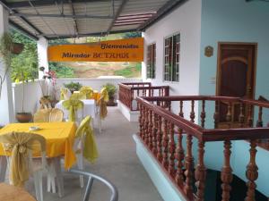 a restaurant with a table with yellow tables and chairs at Hotel Betania in Zamora