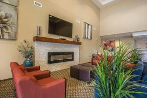 
a living room filled with furniture and a fire place at Comfort Suites Regina in Regina
