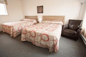 מיטה או מיטות בחדר ב-Motel Blanche d'Haberville