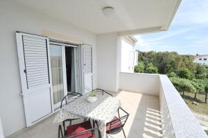a small balcony with a table and chairs on it at Villa Luna with Seaview in Petrcane