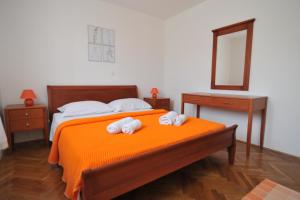 a bedroom with a bed with two towels on it at Villa Luna with Seaview in Petrcane