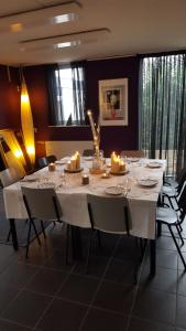 a dining room table with candles on it at B&B Bovenweg in Rhenen