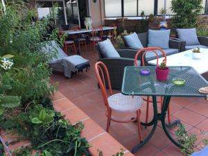 a patio with a table and chairs and tables at B&B La Terrazza Sul Mare Taormina in Taormina