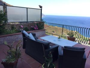 a patio with a table and chairs and the ocean at B&B La Terrazza Sul Mare Taormina in Taormina