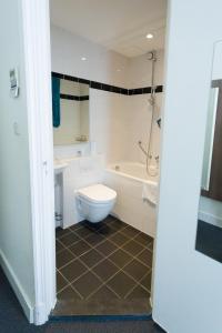 a bathroom with a toilet and a tub and a sink at Hotel Park Plantage in Amsterdam
