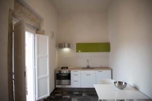 a kitchen with a sink and a stove at Hotel Dell'Orologio in Ragusa