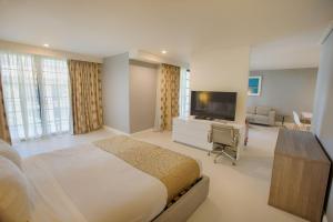 a bedroom with a bed and a flat screen tv at Polynesian Residences Waikiki Beach in Honolulu