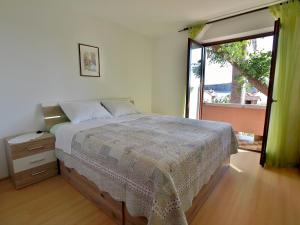 Postel nebo postele na pokoji v ubytování Apartments Fabijanić
