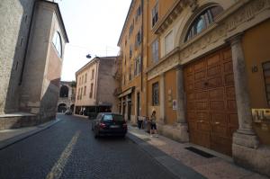 a car parked on the side of a street with buildings at Room Verona Ai Duchi in Verona