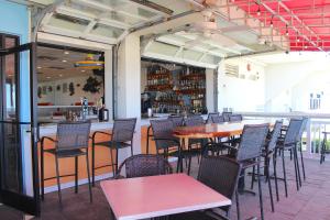 a restaurant with tables and chairs and a bar at Ocean Sands Resort by VSA Resorts in Virginia Beach