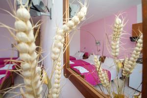 a room with a mirror and a bedroom with a bed at Athena Kythera in Dhiakofti