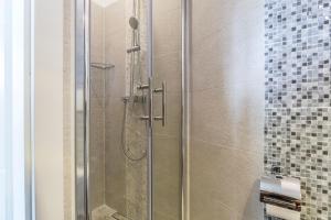 a shower with a glass door in a bathroom at Apartments Lavanda & Rozmarin in Split