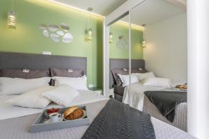 a bedroom with two beds with a tray of food on it at Apartments Lavanda & Rozmarin in Split
