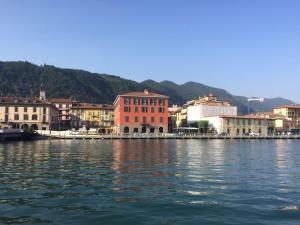 a group of buildings on the shore of a body of water at Casa San Paolo in Sarnico