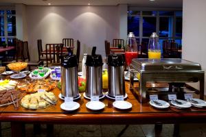 a table filled with food at JVA Fenix Hotel in Uberlândia