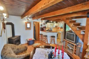 ein Wohnzimmer mit einem Tisch und einer Küche in der Unterkunft Holiday Home Tržan in Josipdol