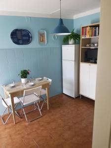 a kitchen with a table and chairs and a refrigerator at Accasamia Terricciola in Terricciola