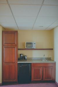 a kitchen with a sink and a microwave at The Hotel Ottumwa in Ottumwa