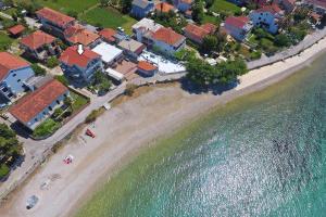 an aerial view of a beach with houses and the water at Apartments Children's paradise in Sukošan