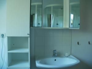 a white bathroom with a sink and a cabinet at la ferme fleurie in Echinghen +28 photos