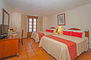 Ένα ή περισσότερα κρεβάτια σε δωμάτιο στο Villa Blanca Huatulco