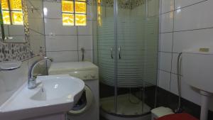 a bathroom with a toilet and a sink and a shower at Villa Katerina Holiday Apartments in Agia Fotia