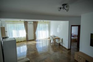 a living room with a table and a dining room at C&Y Apartments Aqua Park in Mamaia
