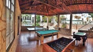 a room with two ping pong tables in a building at Hotel São Francisco in Penedo