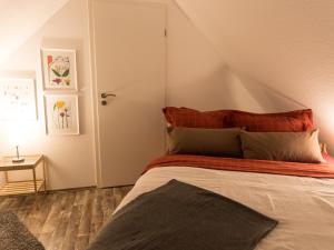 a bedroom with a bed with a red headboard at Borner Schlafwandler in Born