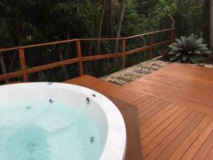 a hot tub sitting on a wooden deck at Chalé Boutique Blumenhof in Blumenau