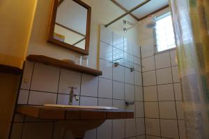 a bathroom with a sink and a mirror at Hostal Hansi in Bocas Town +70 photos