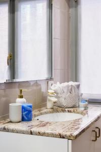 a bathroom counter with a sink and a mirror at Lora Center apartment in Como
