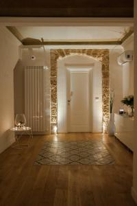 a hallway with a white door and a rug at Petrosino in Palermo