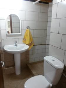 a bathroom with a white toilet and a sink at Sea&Stone Apartment in Skala Sotiros +37 photos