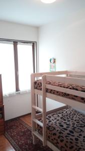 a bedroom with two bunk beds and a window at Villaggio Bianco in San Giacomo