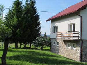 a building with a balcony on the side of it at Natasa Apartments in Jezerce