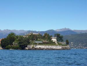 a house on an island in the middle of the water at Albergo Ristorante Pace in Bognanco