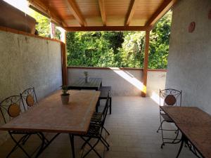 a patio with two tables and chairs and trees at B&B Falcone in Ortona