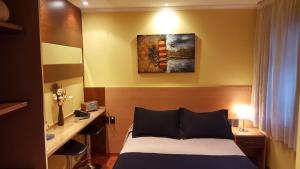 Postel nebo postele na pokoji v ubytování Sur Hotel