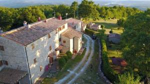 an aerial view of a large house with a road at Agriturismo I Monti in Semproniano