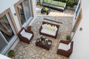 an overhead view of a patio with chairs and a table at Athena Kythera in Dhiakofti