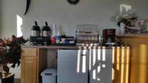 a kitchen with a counter and a refrigerator in a room at American Inn Motel Canon City in Canon City