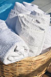 a basket filled with white towels on a table at Driopes Villas in Koroni