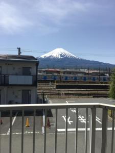 a view of a snow covered mountain from a balcony at Fuji scenic house 73 in Fujikawaguchiko +65 photos