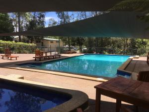 a pool with a pool table and chairs in it at Discovery Parks - Lane Cove in Sydney