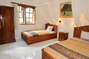 Postel nebo postele na pokoji v ubytování Yuliati House Ubud