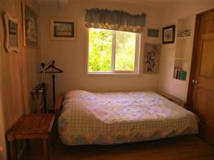 a bedroom with a bed and a window at Grace and Bill's Freedom Hills B&B in Talkeetna